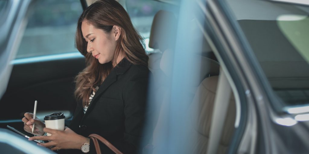 business woman working in car