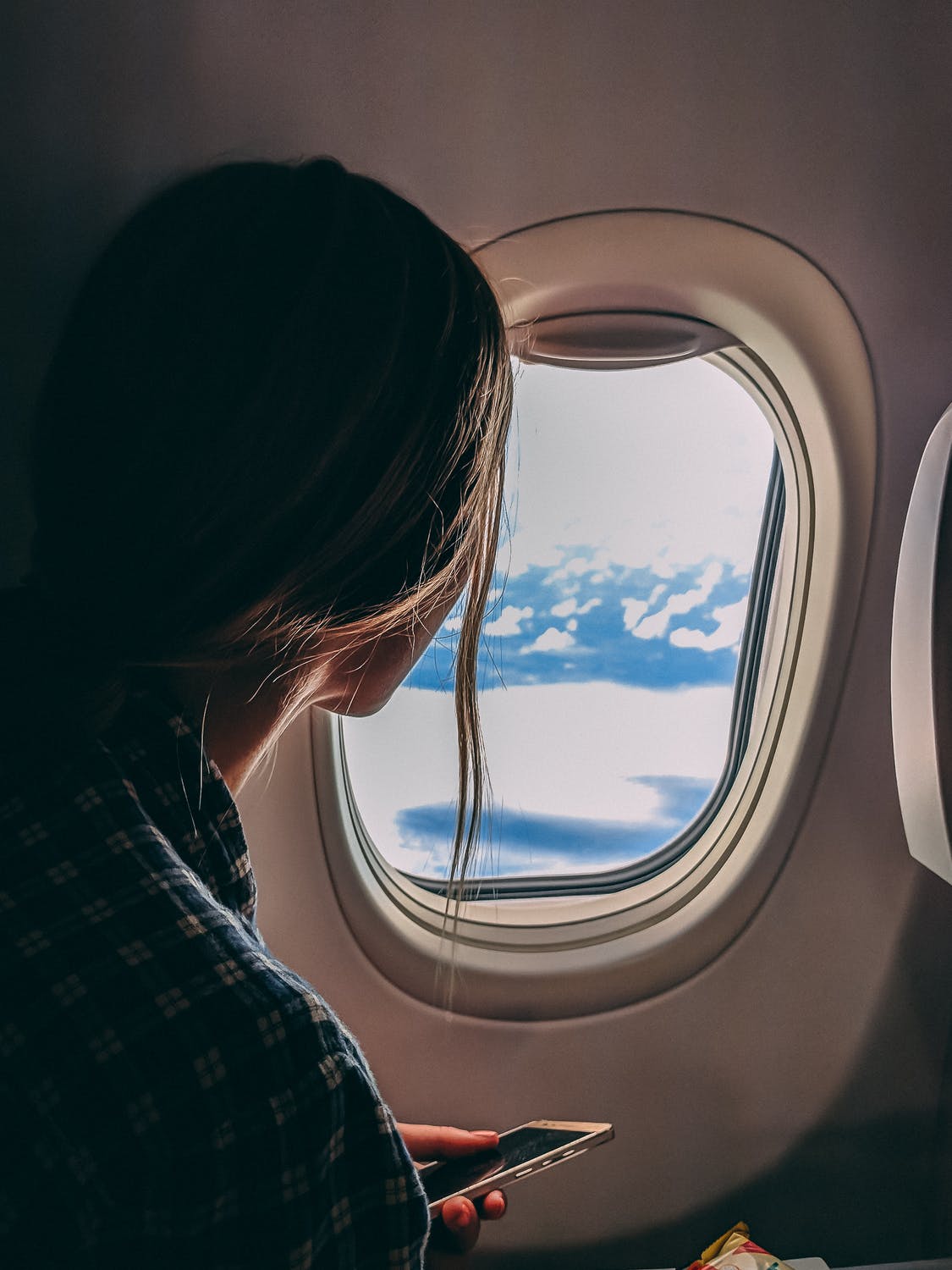 Woman looking out of airplane